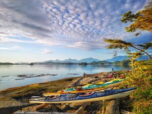 Ocean Vista with Sea kayaks on rocky beach